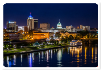 Downtown Montgomery skyline at sunset near Roses RV River Resort